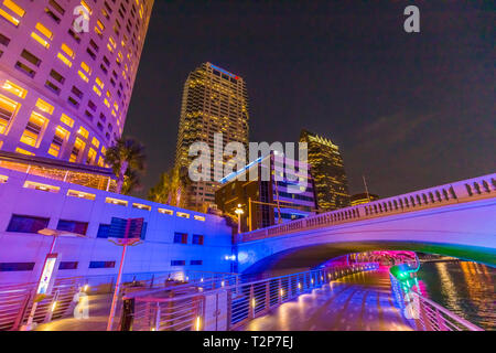 Downtown Tampa Florida buildings lit up at night with colorful lights as seen from the Tampa Riverwalk Stock Photo