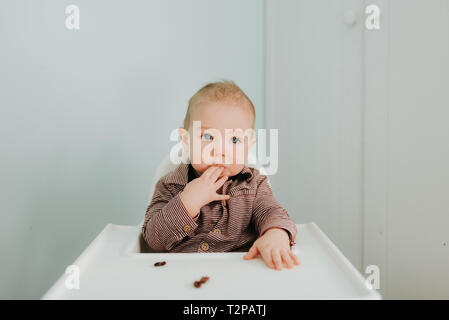 Baby boy in high chair, portrait Stock Photo