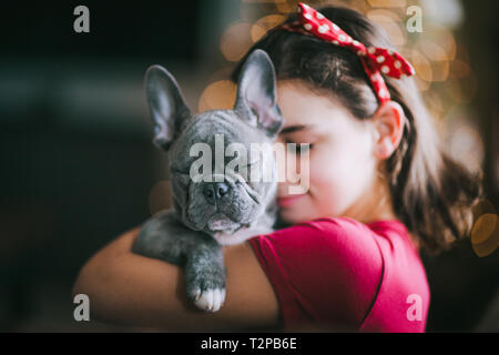 Girl hugging pet dog Stock Photo