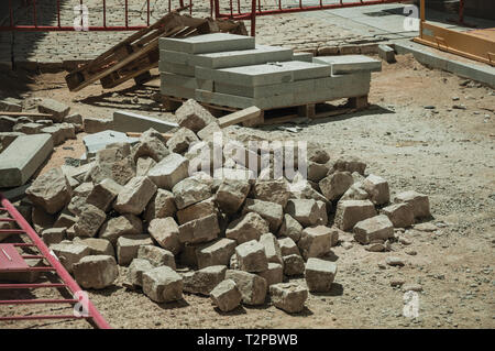 Close-up of setts stones pile in a construction site of street being renovated at Avila. With an imposing wall around the gothic city center in Spain. Stock Photo