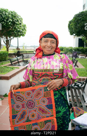 Guna / Kuna woman selling molas (hand-made textile designs made of a number of layers by hand stitches) near Paseo de las Bóvedas, Panama City, Panama Stock Photo