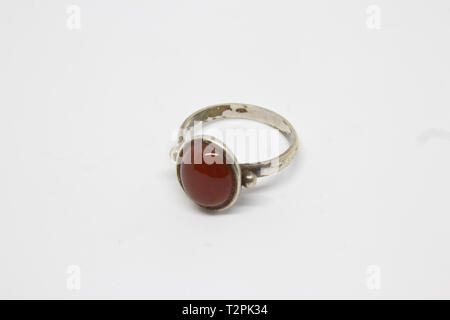 antique silver ring with red ruby closeup shoot. photo has taken with photobox with white background. Stock Photo