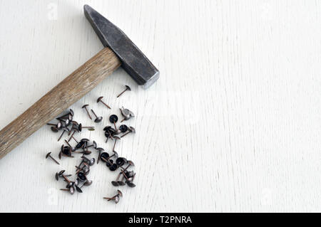 hammer and nails on a wooden table. concept for designer Stock Photo