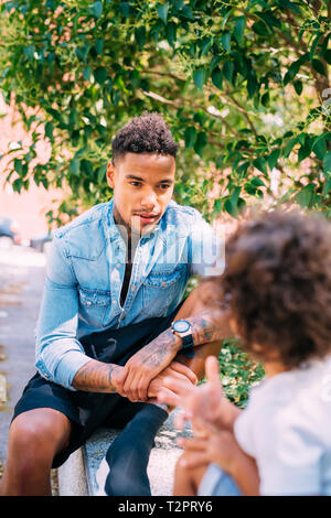 Father and son talking in park Stock Photo