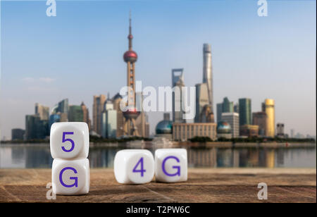 5G spelled in cubes with 4G or LTE blurred behind with city of Shanghai in background Stock Photo
