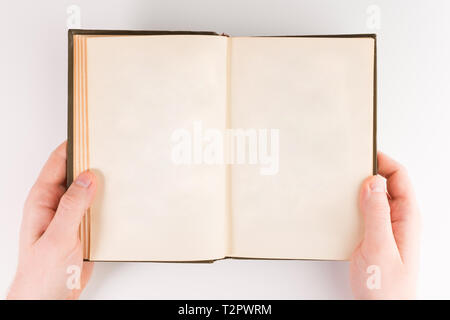 Overhead view of hands holding a blank book ready for text, isolated on white background Stock Photo