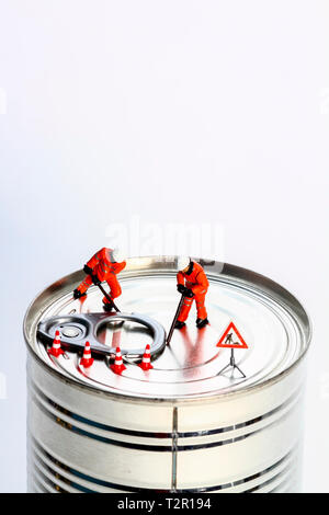 Conceptual diorama image of miniature figures trying to prise open a tin can