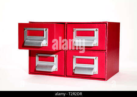 red filing cabinet with one draw open isolated on a white background Stock Photo