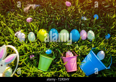 Happy Easter. Easter eggs in a row hidden in spring grass. Holiday decoration Stock Photo