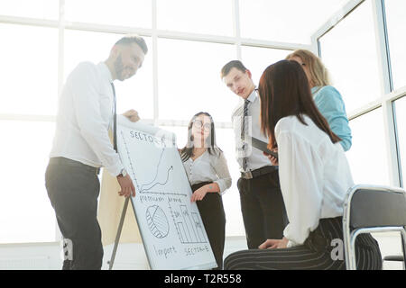 business team standing next to flipchart and discussing their ideas. the concept of teamwork Stock Photo