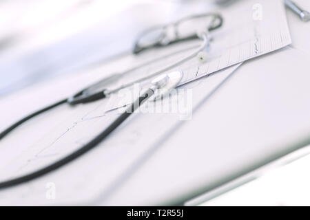 close up. glasses and a stethoscope on the therapist's Desk. photo with copy space Stock Photo