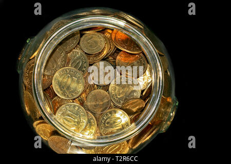 Bunch of golden coins savings in jar Stock Photo