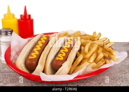 Duo of hot dogs and french fries on table. Fast food restaurant concept. Close up. Copy space for your text. Stock Photo