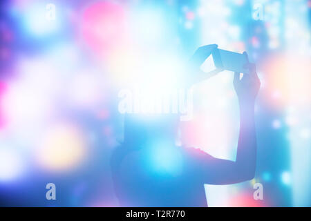 Silhouette of Woman Taking a Photo in An Abstract Space Stock Photo