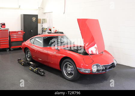 Classic Toyota 2000GT on the shop floor. Taken at a local car show near Fort Lauderdale, Florida, USA. Classic car lovers will recognize this icon. Stock Photo