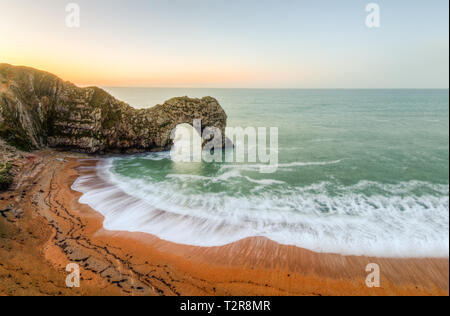 The epic Durdle's door on the Jurassic coast in Dorset, This image was taken shortly after sunrise Stock Photo