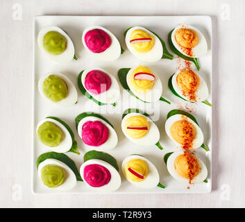 A plate of deviled eggs on dark grey stone background, top view Stock Photo