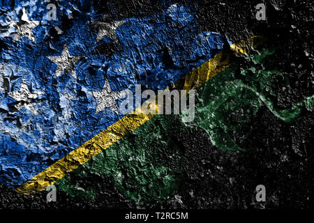 Solomon Islands smoky mystical flag on the old dirty wall background Stock Photo