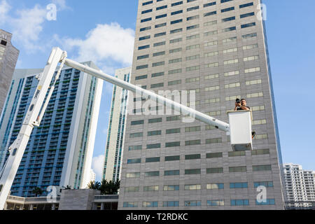 Miami Florida,Biscayne Boulevard,office building,cherry picker,boom lift,basket crane,photographer,man men male,perspective,look down,FL090430025 Stock Photo