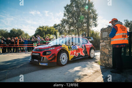 Regino, Corsica - 31st March 2019. Spectators and a marshall watch as S. Ogier & J. Ingrassia take a corner during Special Stage SS13 between Regino a Stock Photo