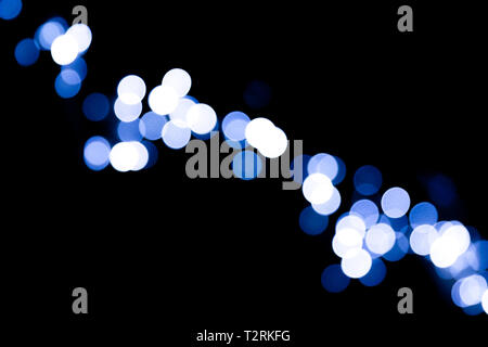Unfocused abstract colourful bokeh black background. defocused and blurred many round blue light. Stock Photo