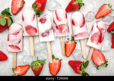 Homemade frozen strawberry ice cream popsicles and fresh strawberries ...