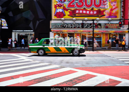 Pictured is a taxi driving in Tokyo Japan. Stock Photo