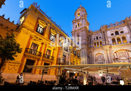Malaga Cathedral and the Bishops Palace lit up at night, seen from the Plaza del Obispo, Malaga old town, Andalusia Spain