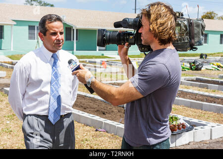 Miami Florida,Liberty City,Square,public housing,ceremony,dedication,community garden,plot,allotment,urban,gardening,green movement,Hispanic man men m Stock Photo