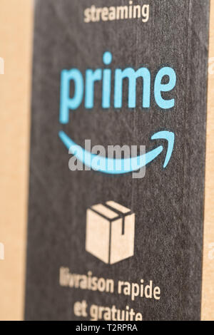 DRESDEN, GERMANY - APRIL 3, 2019 : Close up of Amazon Prime logo on tape of delivered parcel. Prime is a service offered by online retailer Amazon for Stock Photo