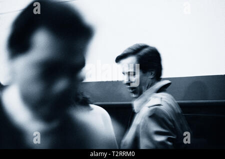 Black and white image of two businessmen passing each other Stock Photo