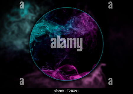 Close-up   thick pink and blue smoke blown under a magnifying glass on a black isolated background. Background from the smoke of vape Stock Photo