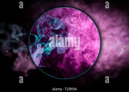 Close-up   thick pink and blue smoke blown under a magnifying glass on a black isolated background. Background from the smoke of vape Stock Photo