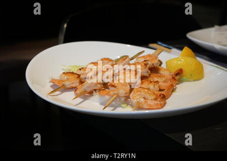 Grilled tiger shrimps skewers with lemon - seafood style Stock Photo