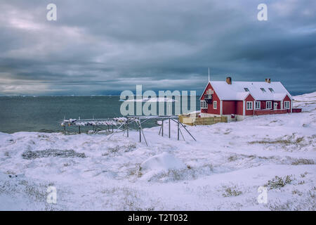 Single wooden house in the snow-covered disco bay of Ilulissat in Greenland Stock Photo