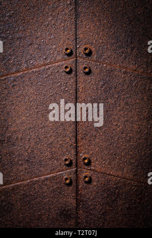 detail of a series of metal plates corroded by time and covered with rust that creates the corten effect. Stock Photo