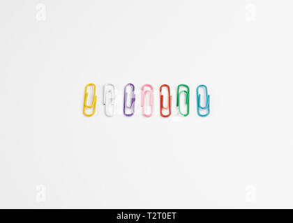 Row of Coloured paper Clips on White Background Stock Photo