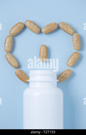 Heart shape created from herbal pills and bottle pills, useful as mockup Stock Photo