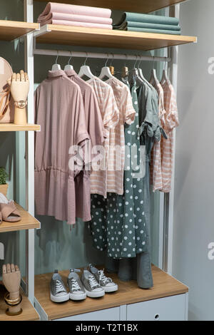 Stylish clothes, shoes and accessories in large wardrobe closet Stock Photo