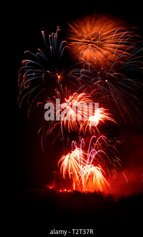 Bursts of red fireworks against a black sky Stock Photo
