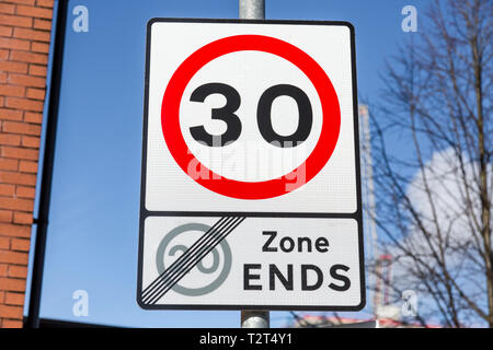 A UK Road Traffic 30 mph speed limit sign signifying the end of a 20 mph zone Stock Photo