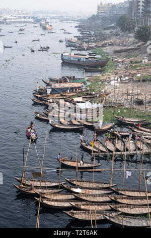 Boats crossing Buriganga river, Dhaka. They carry people and cargo. Babubazar bridge view. Rivers are important part of Bangladesh transport system. Stock Photo