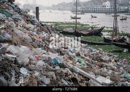 Dump on the Buriganga river bank, Zinzira district, Keraniganj, Dhaka, Bangladesh. Boats in the background. Stock Photo