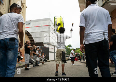 Percussion Ensemble. Young musicians rehearsing on the street with their surdo (marching snare drum) in downtown Panama City, Panama. Oct 2018 Stock Photo