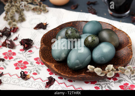 Easter Chicken and Quail Eggs on a plate, painted with tea from the petals of a Sudanese rose or hibiscus Stock Photo