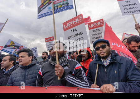 London, UK. 4th April 2019. Private hire drivers block London Bridge in protest against TfL making them pay the congestion charge from April 8th. They accuse TfL of discriminating against private hire drivers who are largely from Black, Asian and minority ethnic groups while black cabs, whose drivers are largely white are still exempt. Today the court decided their Judicial Review would be heard in July, but refused an order to delay charging unti then. Credit: Peter Marshall/Alamy Live News Stock Photo