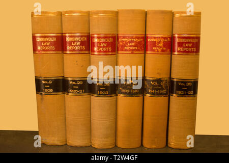 A group of six Commonwealth Law Reports in book form from the early 1900s on a yellow background