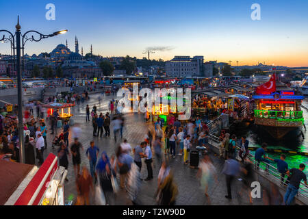 Istanbul, Turkey - August 14, 2018: People eat and walk at the Eminonu Square at dusk on August 14, 2018 in Istanbul, Turkey Stock Photo