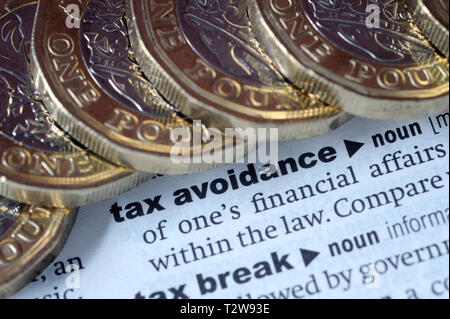 DICTIONARY DEFINITION OF TAX AVOIDANCE WITH ONE POUND COINS RE PENSIONS TAX HMRC ETC UK Stock Photo