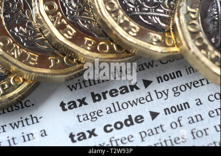 DICTIONARY DEFINITION OF TAX BREAK WITH ONE POUND COINS RE PENSIONS TAX HMRC ETC UK Stock Photo
